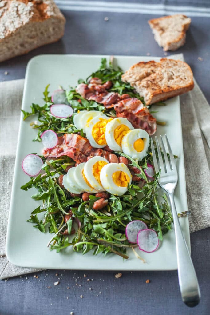 Make a Dandelion Salad with Dandelion greens, Eggs and Bacon for an easy spring dinner! Packed full of vitamins and nutrients! | www.vibrantplate.com