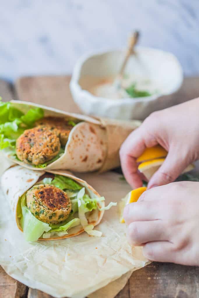 The Easiest Lemon Tahini Falafel Wrap, topped with a delicious Lemon Tahini Sauce is a quick & vegan meal. | www.vibrantplate.com