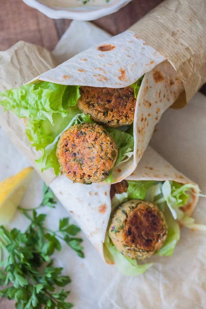 The Easiest Lemon Tahini Falafel Wrap, topped with a delicious Lemon Tahini Sauce is a quick & vegan meal. | www.vibrantplate.com