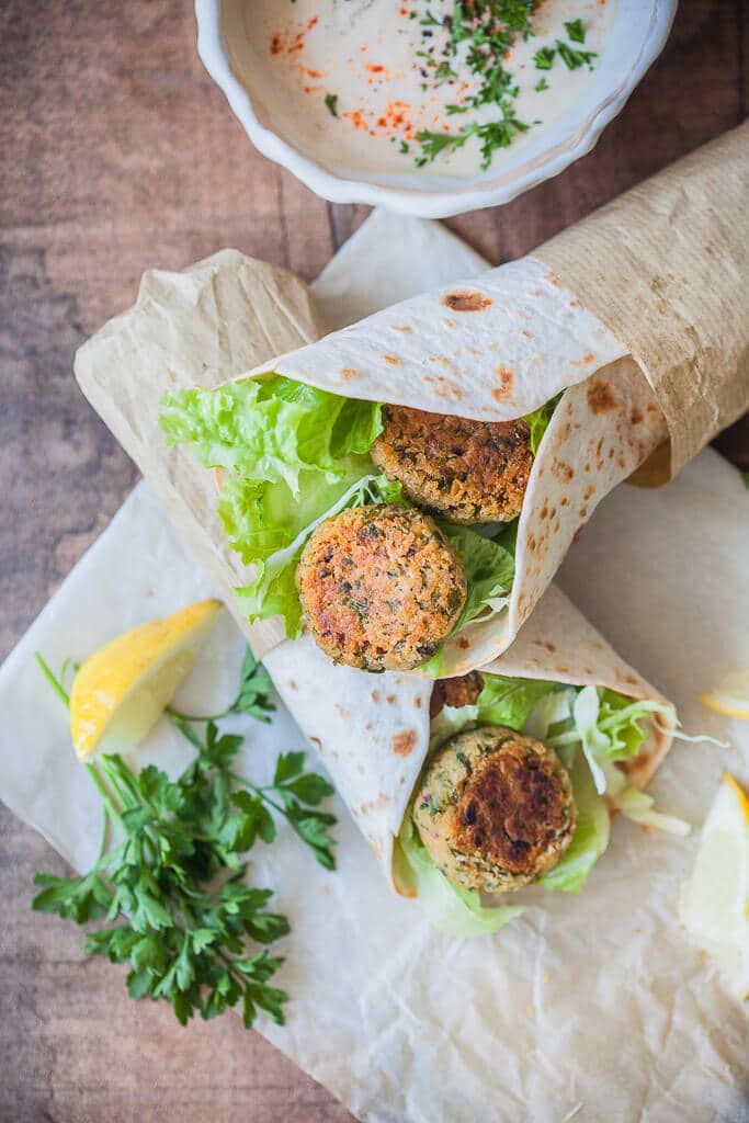 The Easiest Lemon Tahini Falafel Wrap, topped with a delicious Lemon Tahini Sauce is a quick & vegan meal. | www.vibrantplate.com