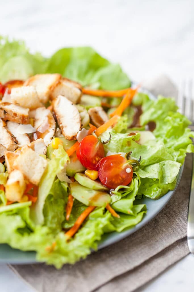 A refreshing and nutritious go-to summer salad with mixed greens, toppings and grilled chicken with balsamic dressing.