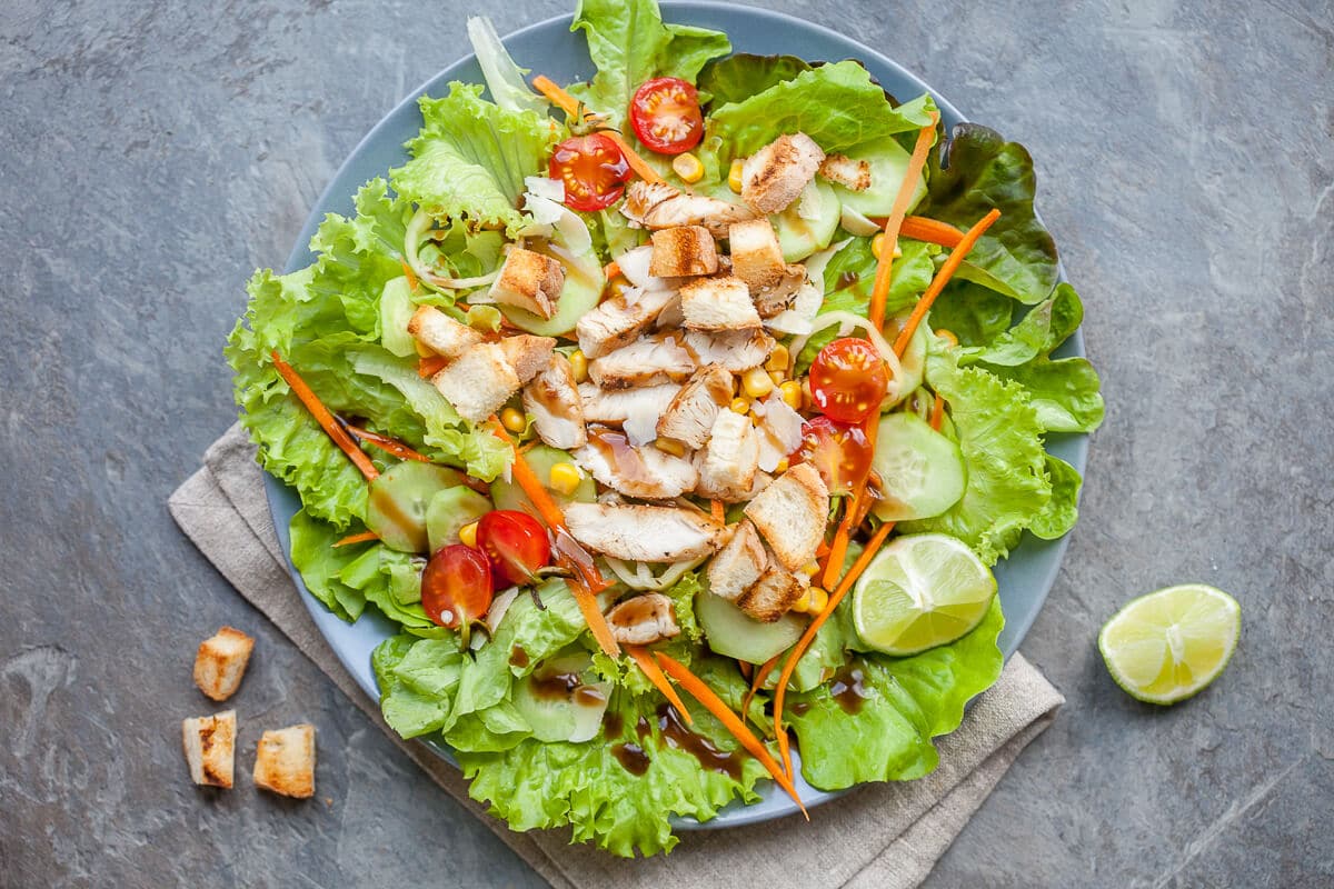 A refreshing and nutritious go-to summer salad with mixed greens, toppings and grilled chicken with balsamic dressing.