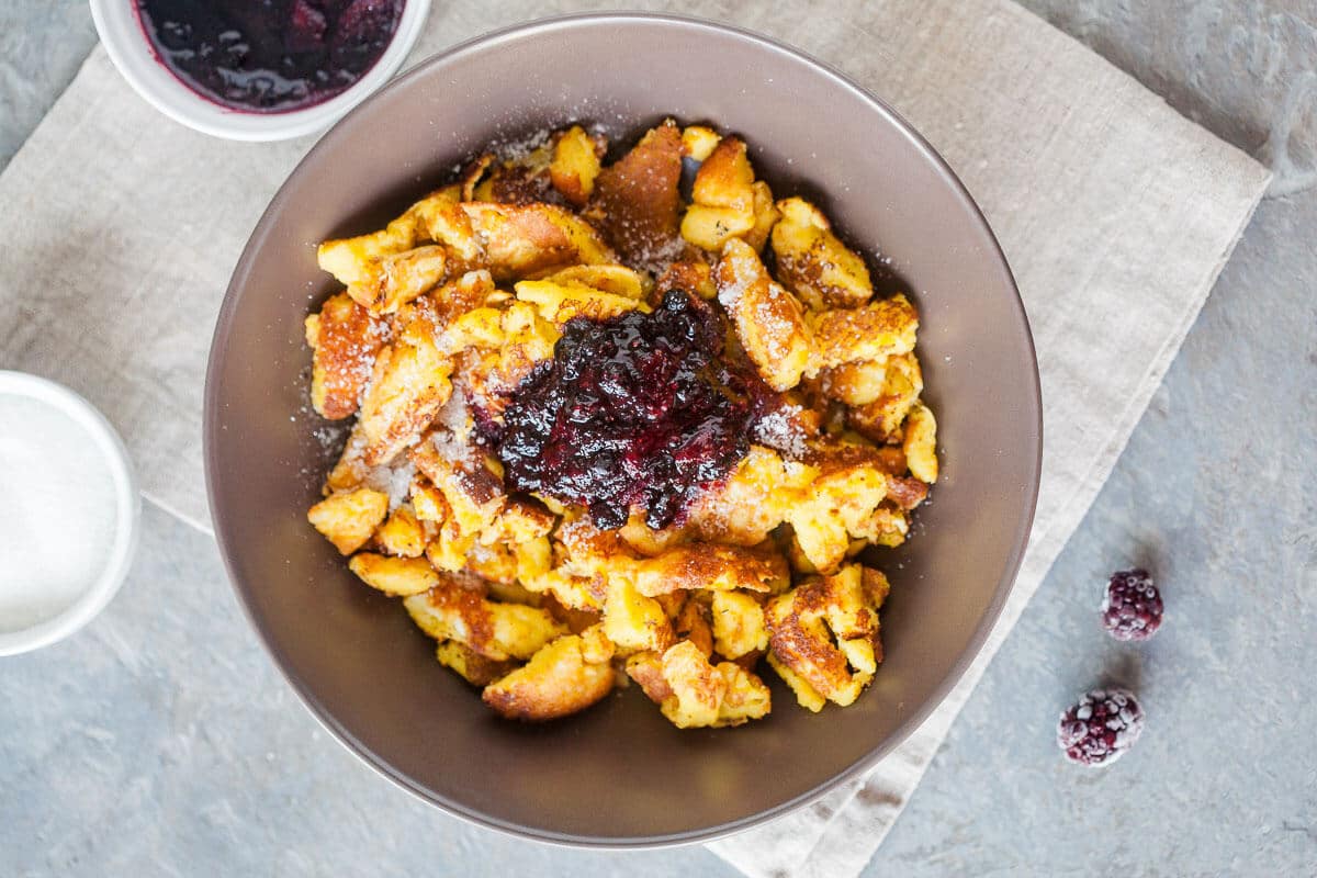 Kaiserschmarrn is a breakfast favorite shredded pancake. Light and fluffy you can also enjoy it for dinner! | www.vibrantplate.com