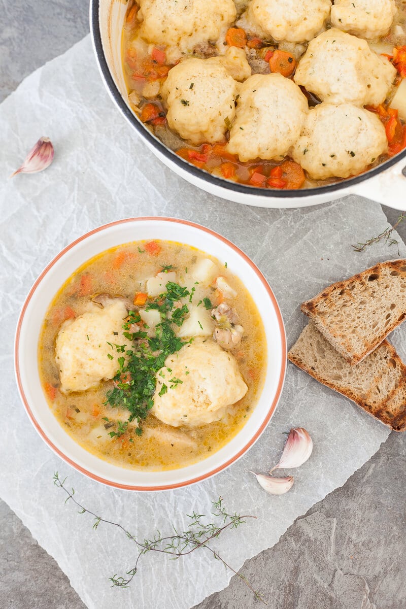 A close up of Chicken Stew with Fluffy Dumplings in a bowl.