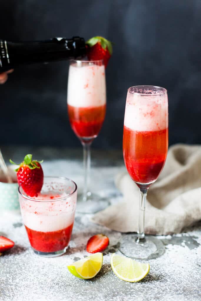 Celebrate Valentine's with this easy & delicious Strawberry Champagne! Mix champagne with strawberry puree for a delightful drink. | www.vibrantplate.com