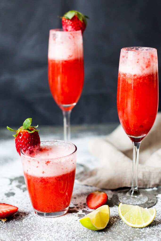 Celebrate Valentine's with this easy & delicious Strawberry Champagne! Mix champagne with strawberry puree for a delightful drink. | www.vibrantplate.com