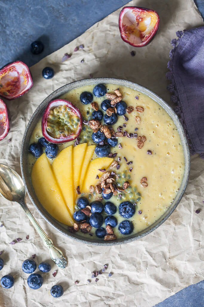 This easy & delicious Mango Smoothie Bowl is a yellow bliss tropical heaven in a bowl! | www.vibrantplate.com