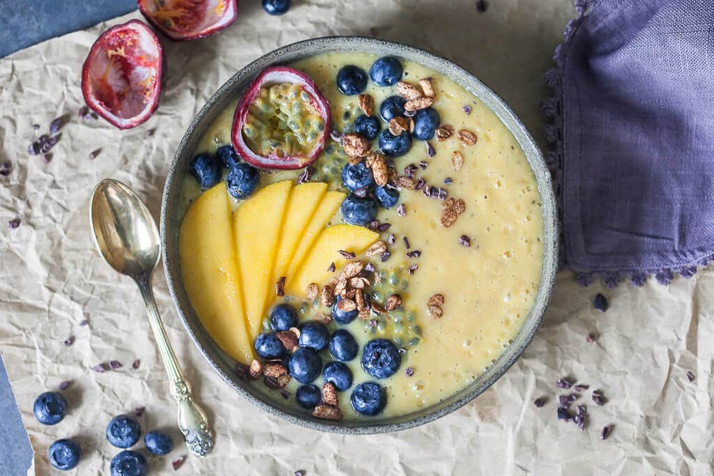 This easy & delicious Mango Smoothie Bowl is a yellow bliss tropical heaven in a bowl! | www.vibrantplate.com