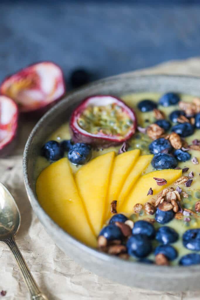 This easy & delicious Mango Smoothie Bowl is a yellow bliss tropical heaven in a bowl! | www.vibrantplate.com