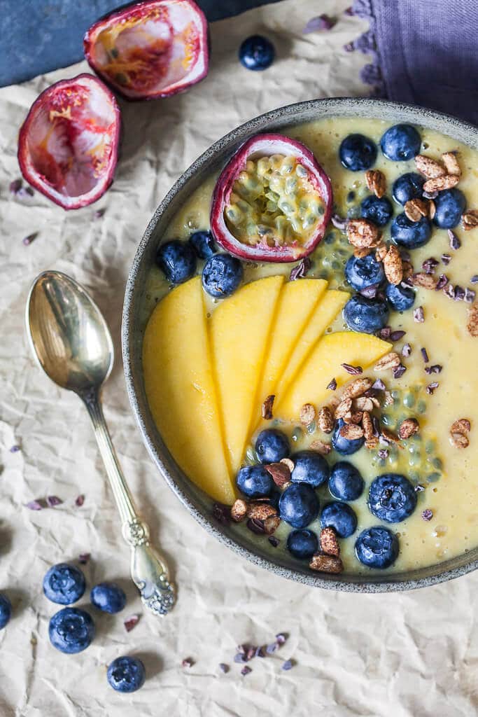 This easy & delicious Mango Smoothie Bowl is a yellow bliss tropical heaven in a bowl! | www.vibrantplate.com