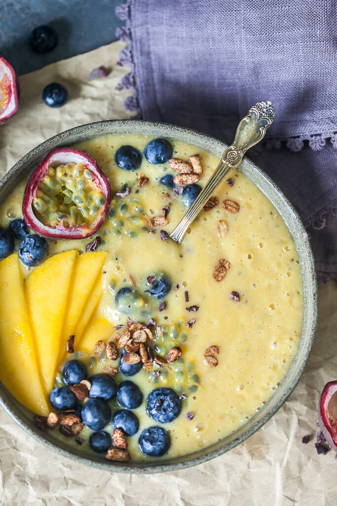 This easy & delicious Mango Smoothie Bowl is a yellow bliss tropical heaven in a bowl! | www.vibrantplate.com