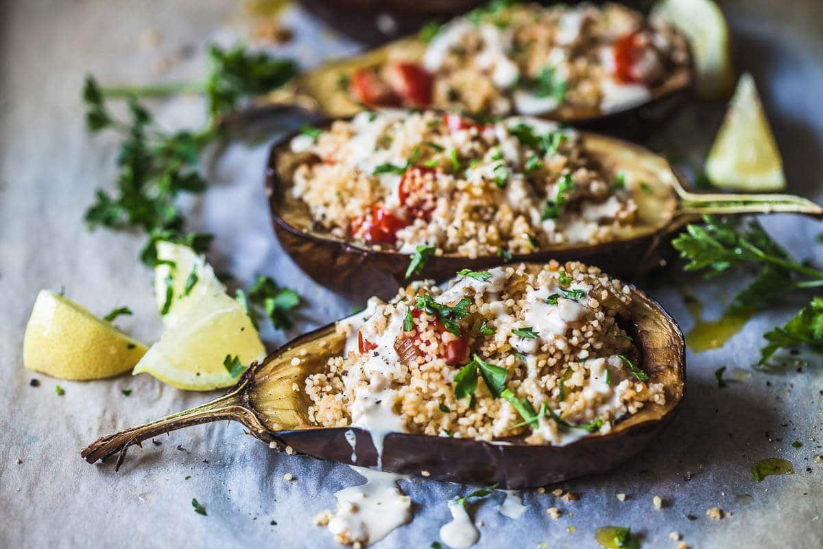 Couscous Stuffed Eggplant topped with a fresh Lemon Tahini Sauce is a delicious way to serve eggplants. Vegan and Dairy-Free! | Vibrant Plate