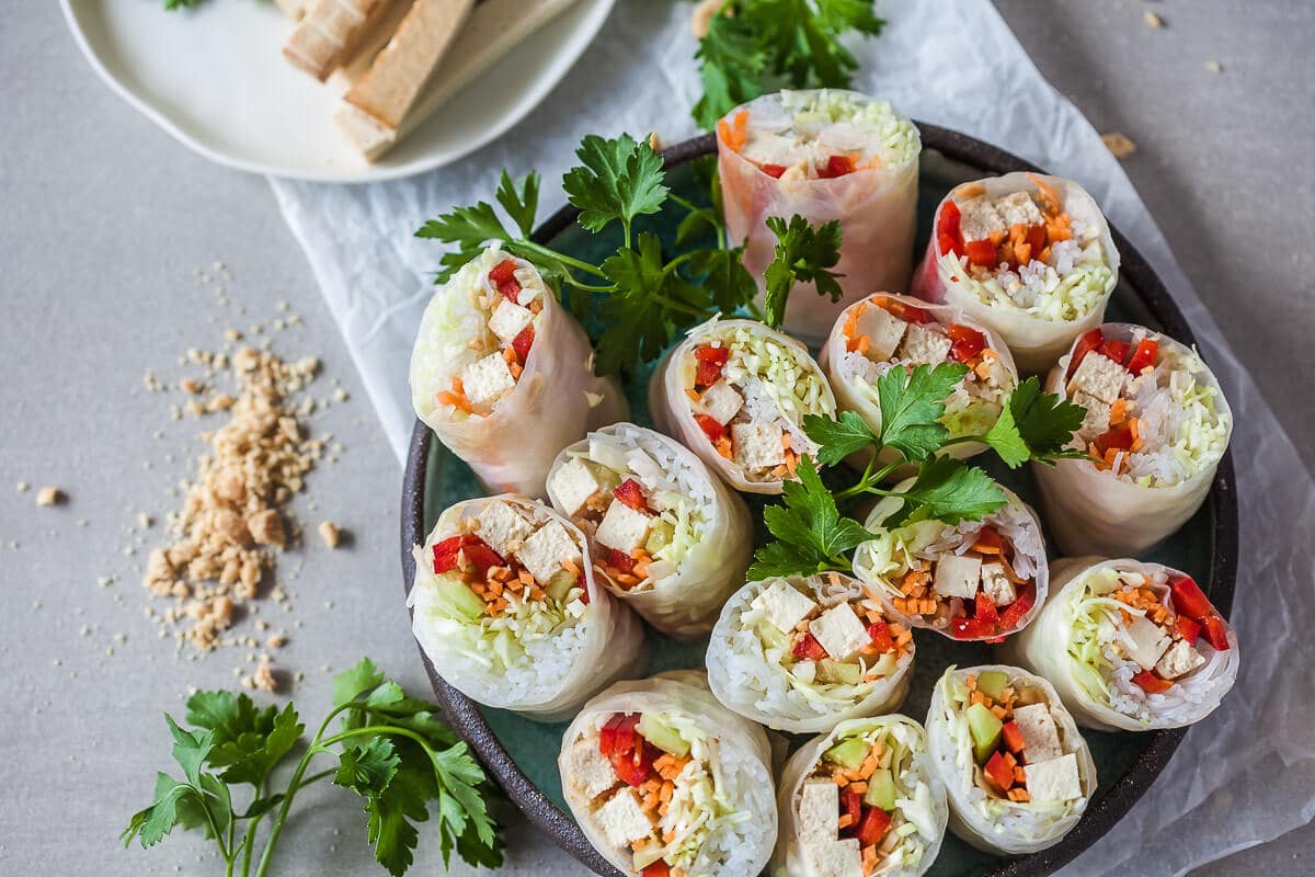 These colorful Vegan Tofu Spring Rolls are paired with a delicious peanut dipping sauce. A delicious gluten-free meal in just 30 minutes! | Vibrant Plate