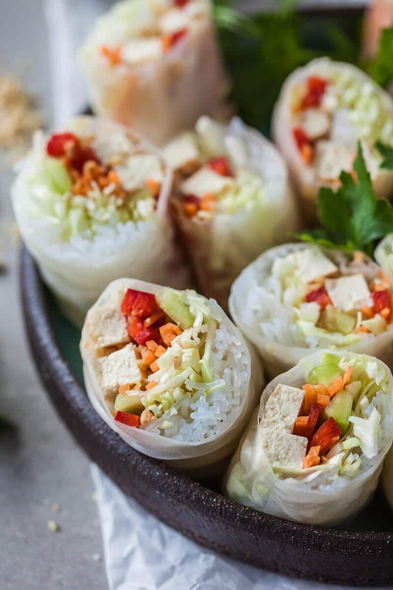 These colorful Vegan Tofu Spring Rolls are paired with a delicious peanut dipping sauce. A delicious gluten-free meal in just 30 minutes! | Vibrant Plate