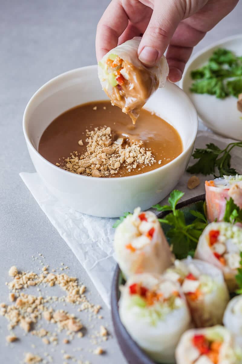 These colorful Vegan Tofu Spring Rolls are paired with a delicious peanut dipping sauce. A delicious gluten-free meal in just 30 minutes! | Vibrant Plate