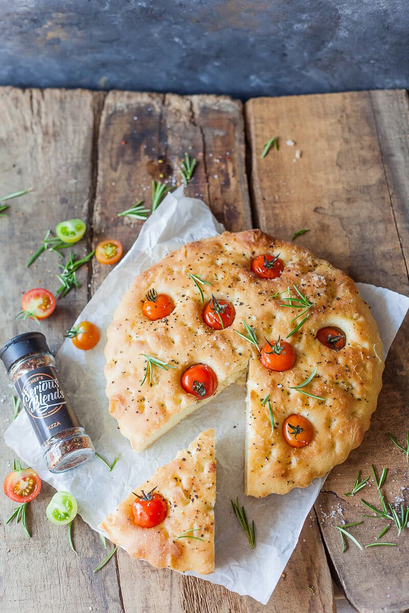 This Cherry Tomato Vegan Focaccia is topped with fragrant cherry tomatoes, coarse salt, and aromatic pizza herbs. | Vibrant Plate