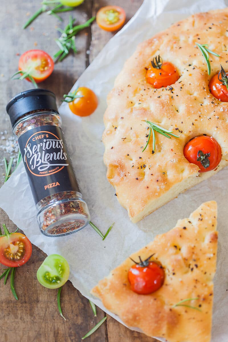 This Cherry Tomato Vegan Focaccia is topped with fragrant cherry tomatoes, coarse salt, and aromatic pizza herbs. | Vibrant Plate