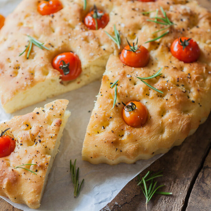 This Cherry Tomato Vegan Focaccia is topped with fragrant cherry tomatoes, coarse salt, and aromatic pizza herbs. | Vibrant Plate