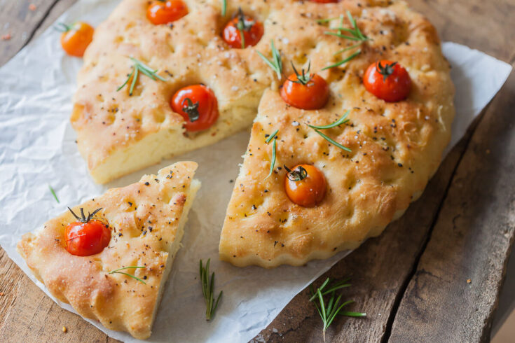 This Cherry Tomato Vegan Focaccia is topped with fragrant cherry tomatoes, coarse salt, and aromatic pizza herbs. | Vibrant Plate