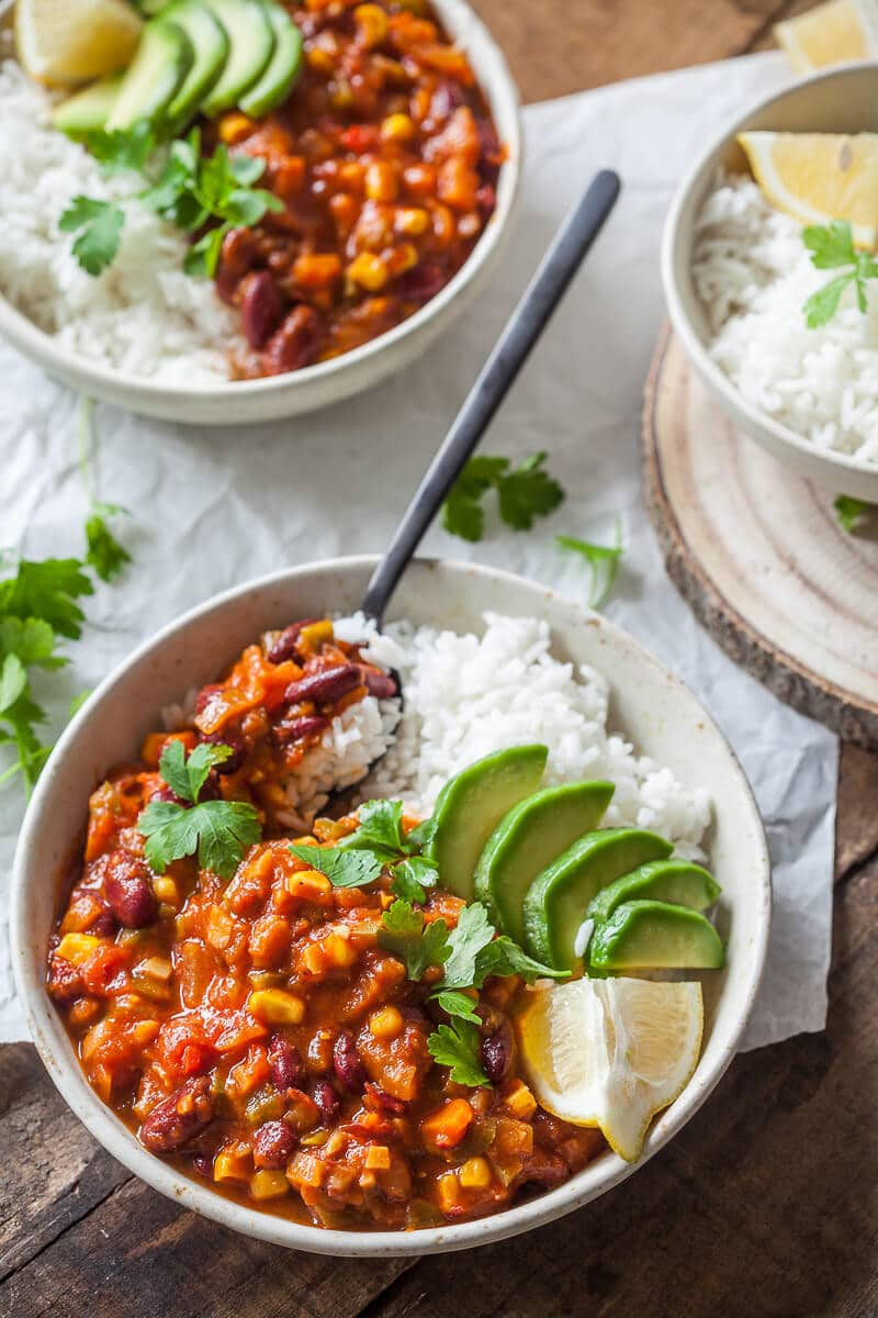 Chili bowl with rice on a plate pictured from above.