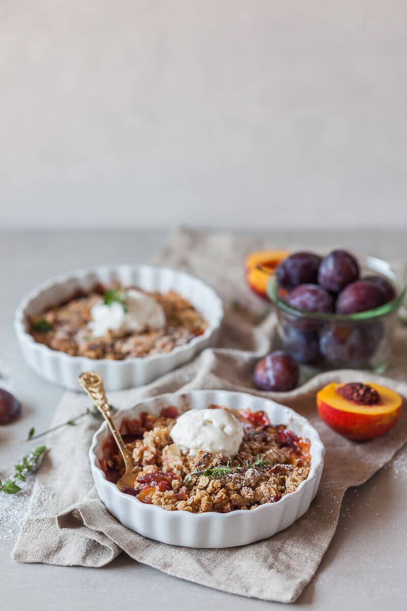 A simply delicious Peach and Plum Vegan Crumble with a crunchy oat and almond topping is a great warm dessert on a cold day. | Vibrant Plate