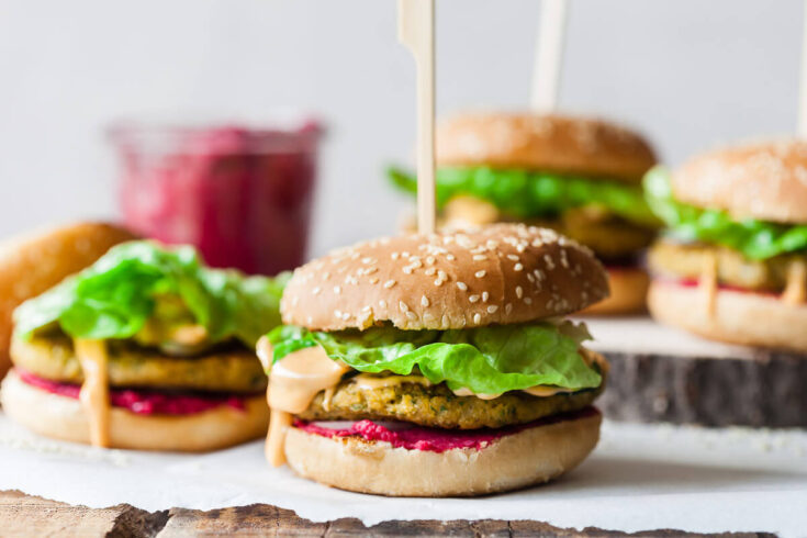 A delicious Vegan Hummus Chickpea Burger with hot pink beetroot hummus and an easy chickpea patty, that will satisfy even the carnivores!